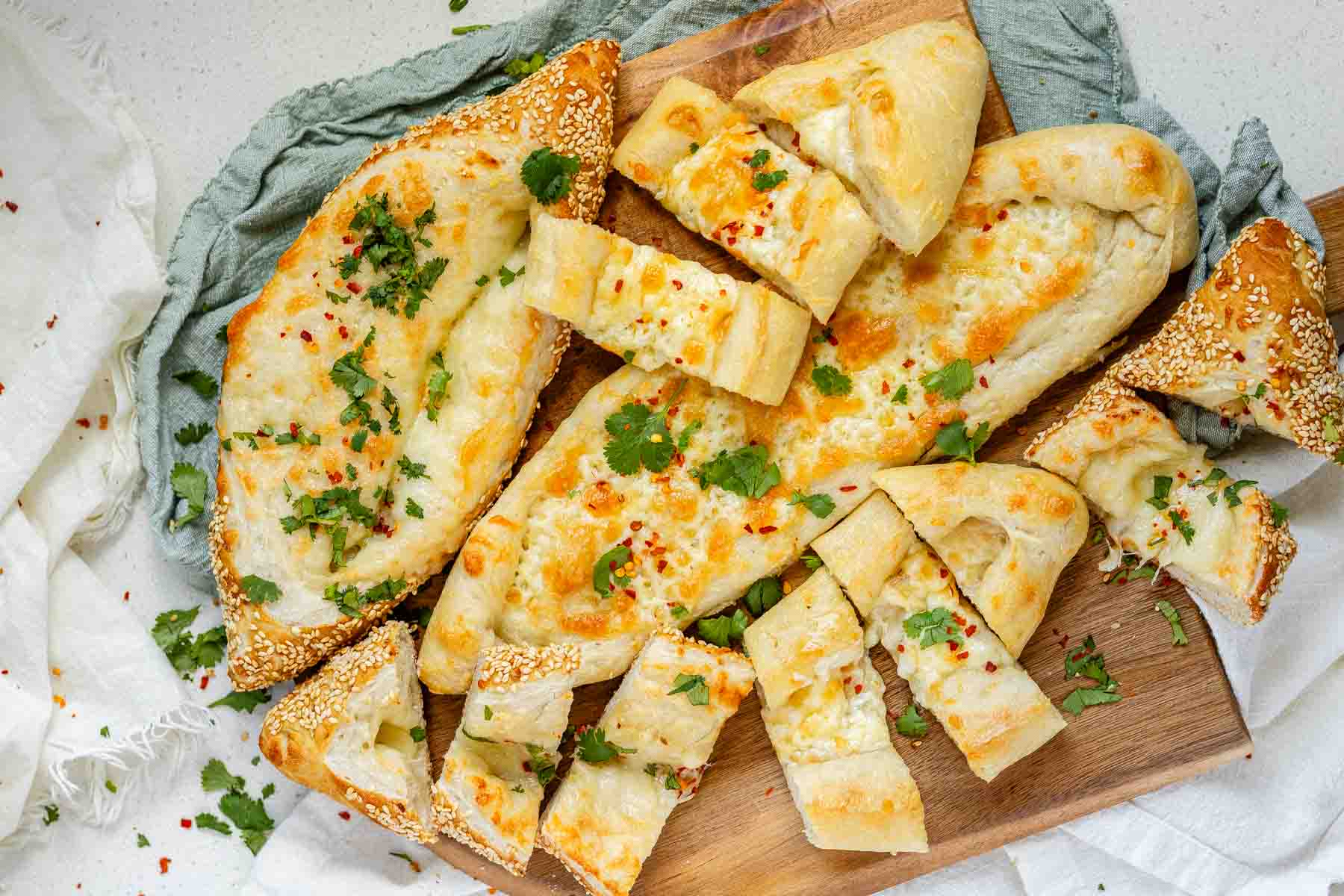 Boat-shaped baked dough filled with melted cheese.