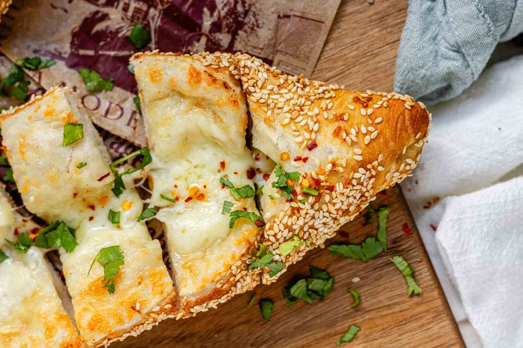 Boat-shaped baked dough filled with melted cheese.