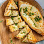 Boat-shaped baked dough filled with melted cheese.