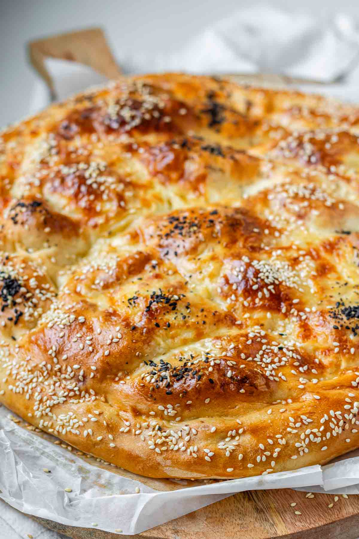 Round flatbread topped with seeds.