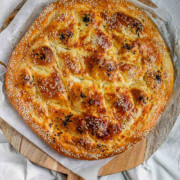 Round flatbread topped with seeds with the text cheese stuffed bread.