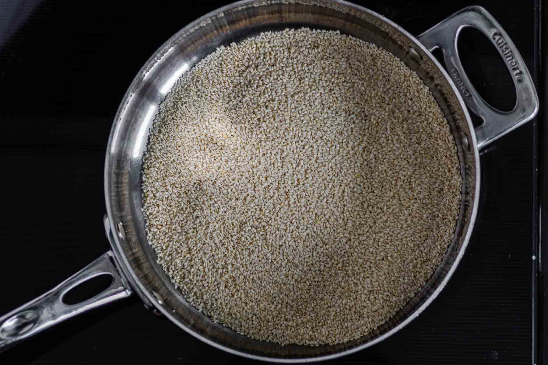 Toasting sesame seeds in a dry skillet.