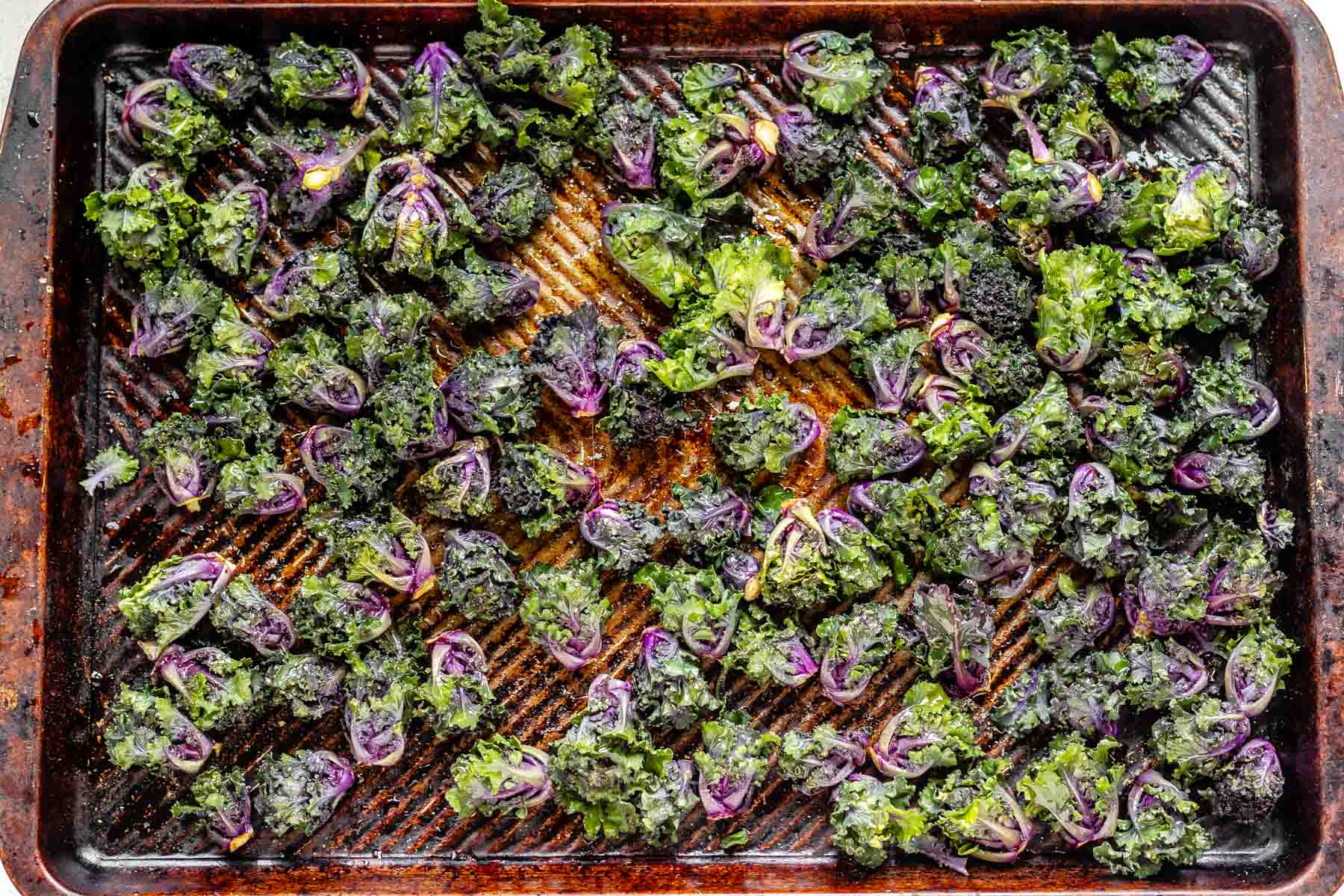 Roasted kalettes on a baking sheet.