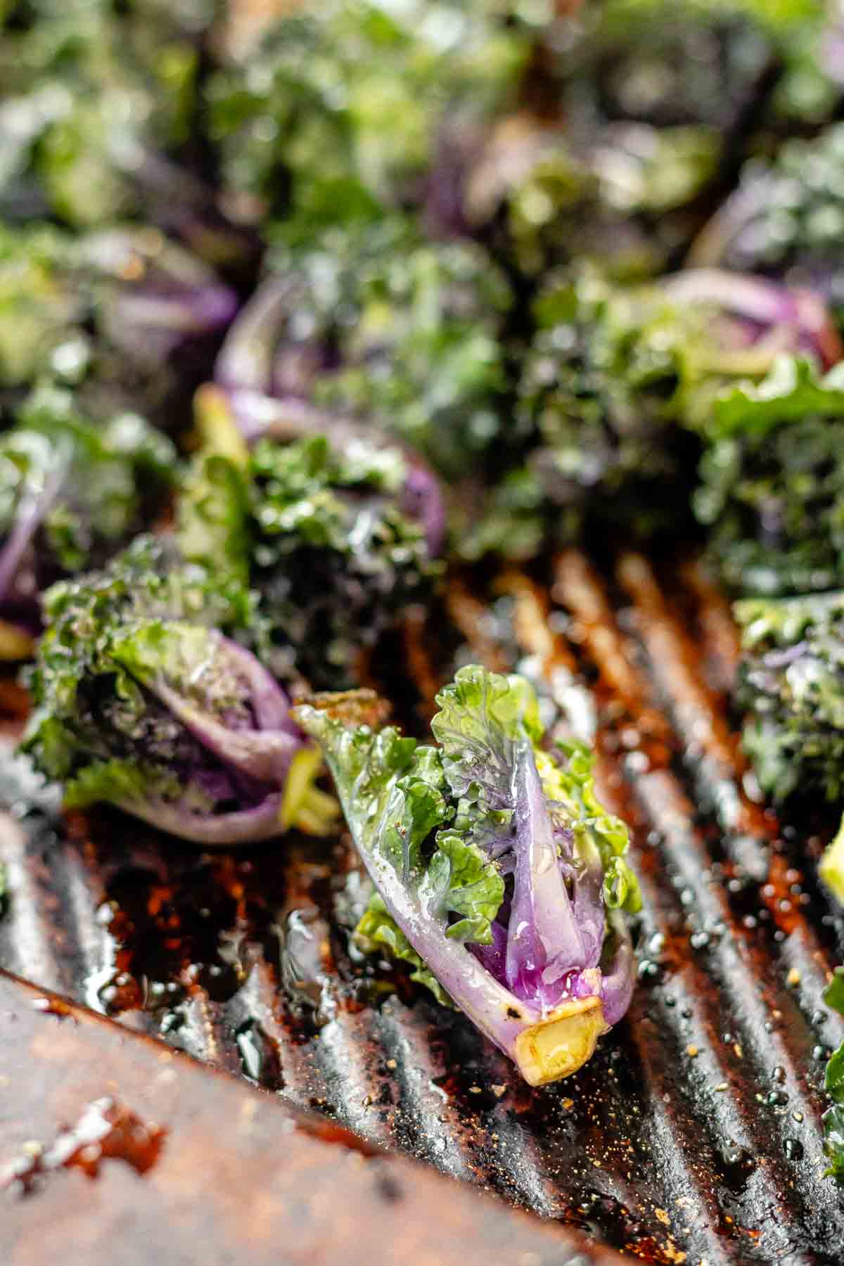 Close-up of roasted kalette on a baking sheet.