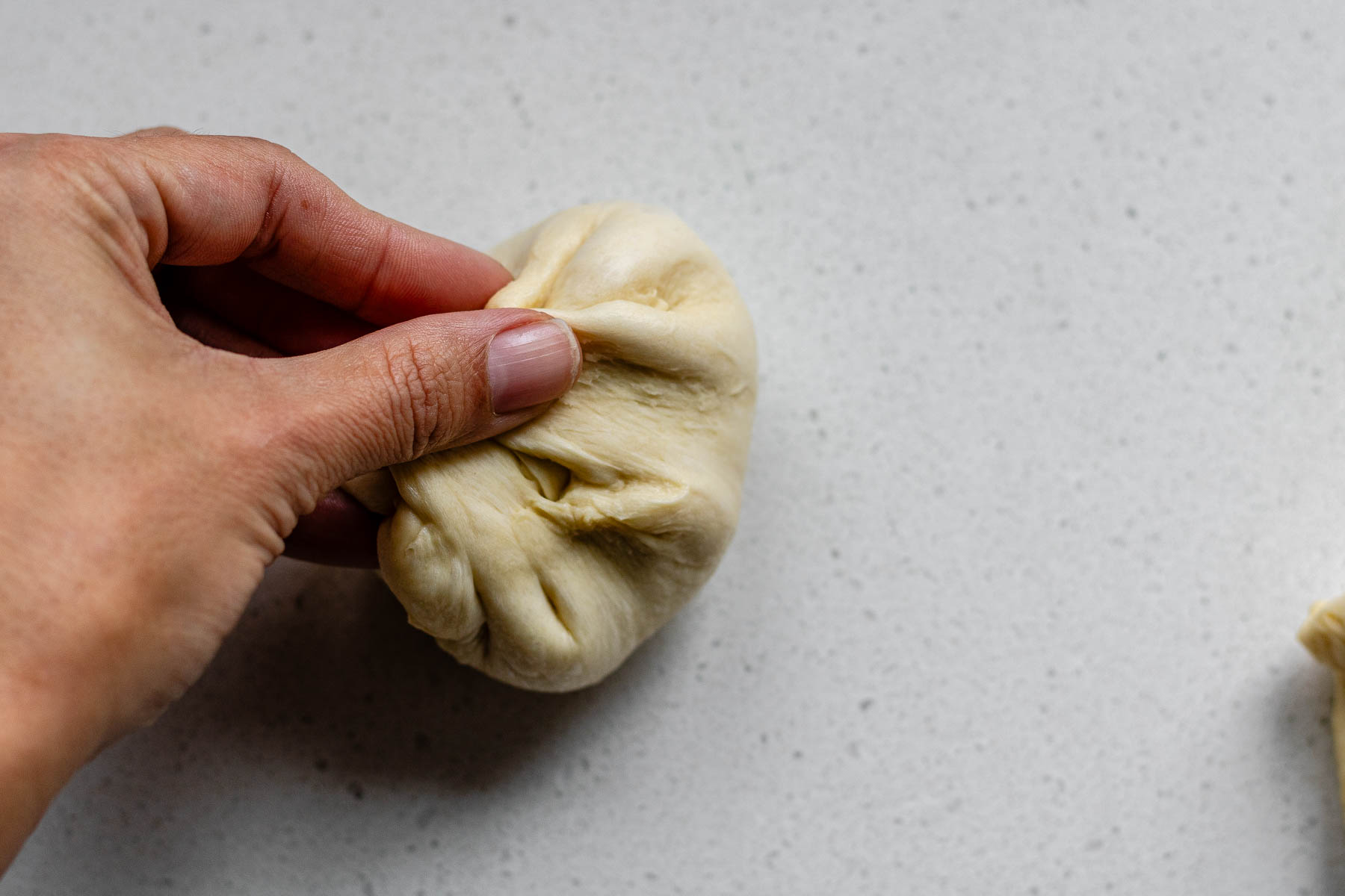 Pinching dough together.