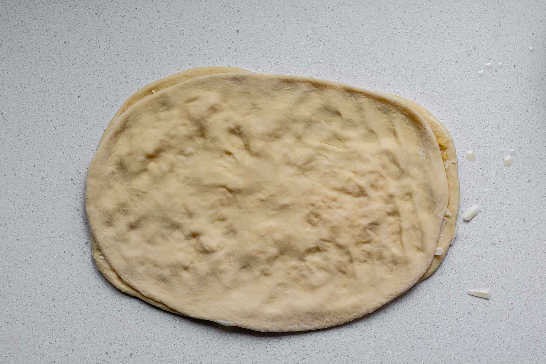 A second rectangle of dough on top of another rectangle of dough.