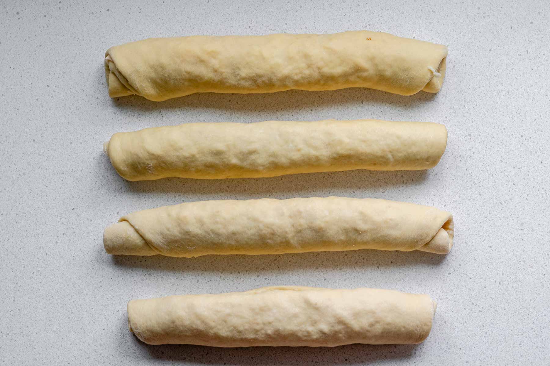 4 rolled logs of dough.