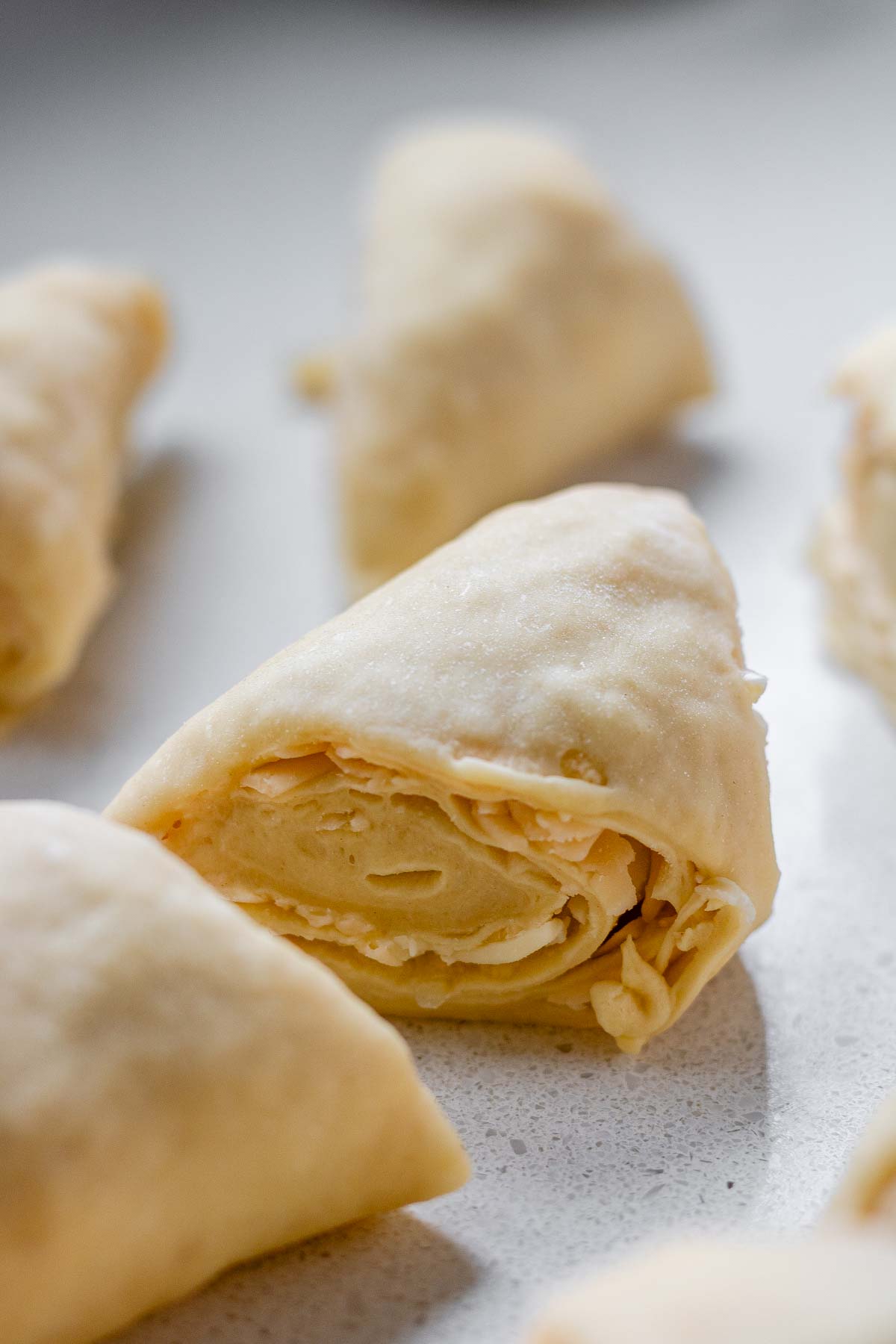 Close up of a rolled triangle of layered dough.