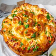 Rolled dough that has been baked and covered with parsley and butter.