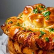 Rolled dough that has been baked and covered with parsley and butter.
