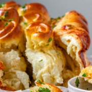 Rolled dough that has been baked and covered with parsley and butter.
