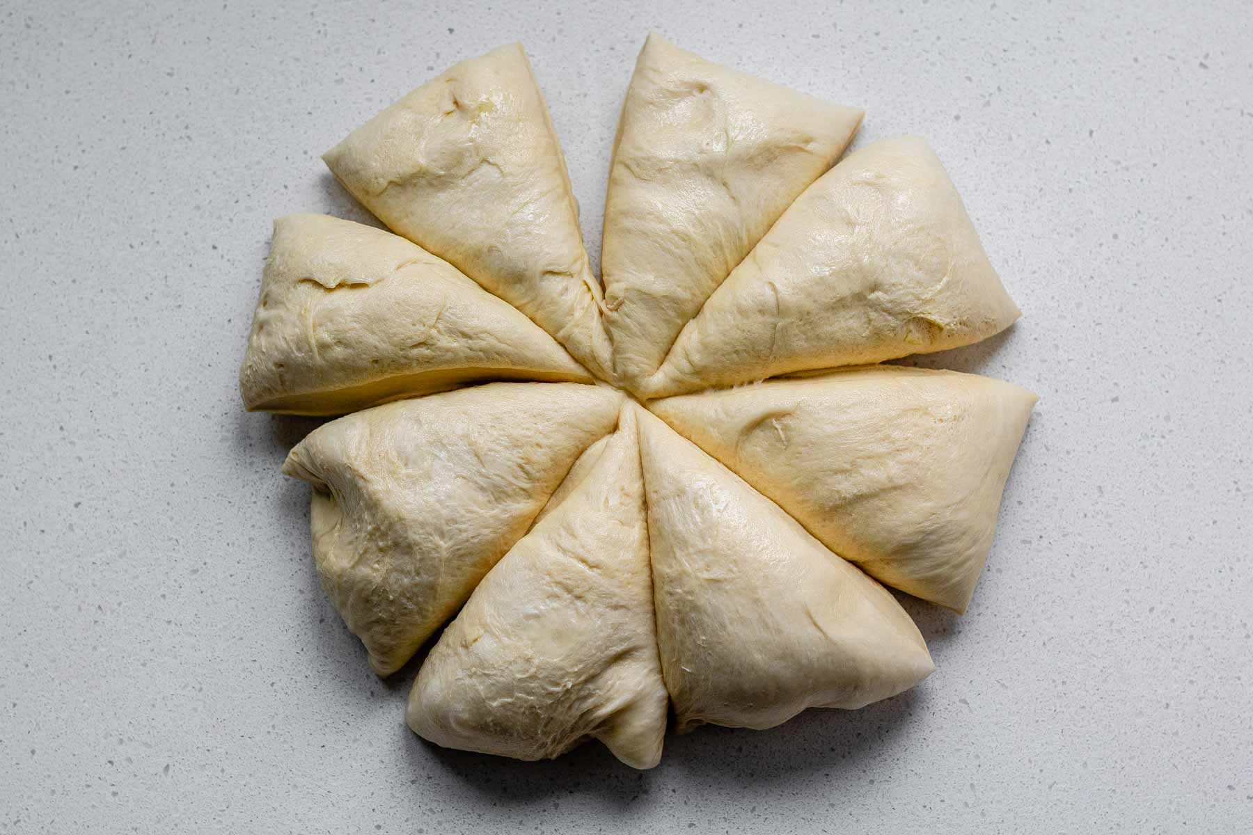 Dough cut into 8 triangles.
