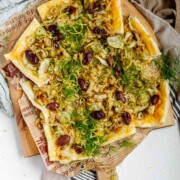 Baked puff pastry topped with fennel, onion, black olives, fresh dill, and lemon zest.