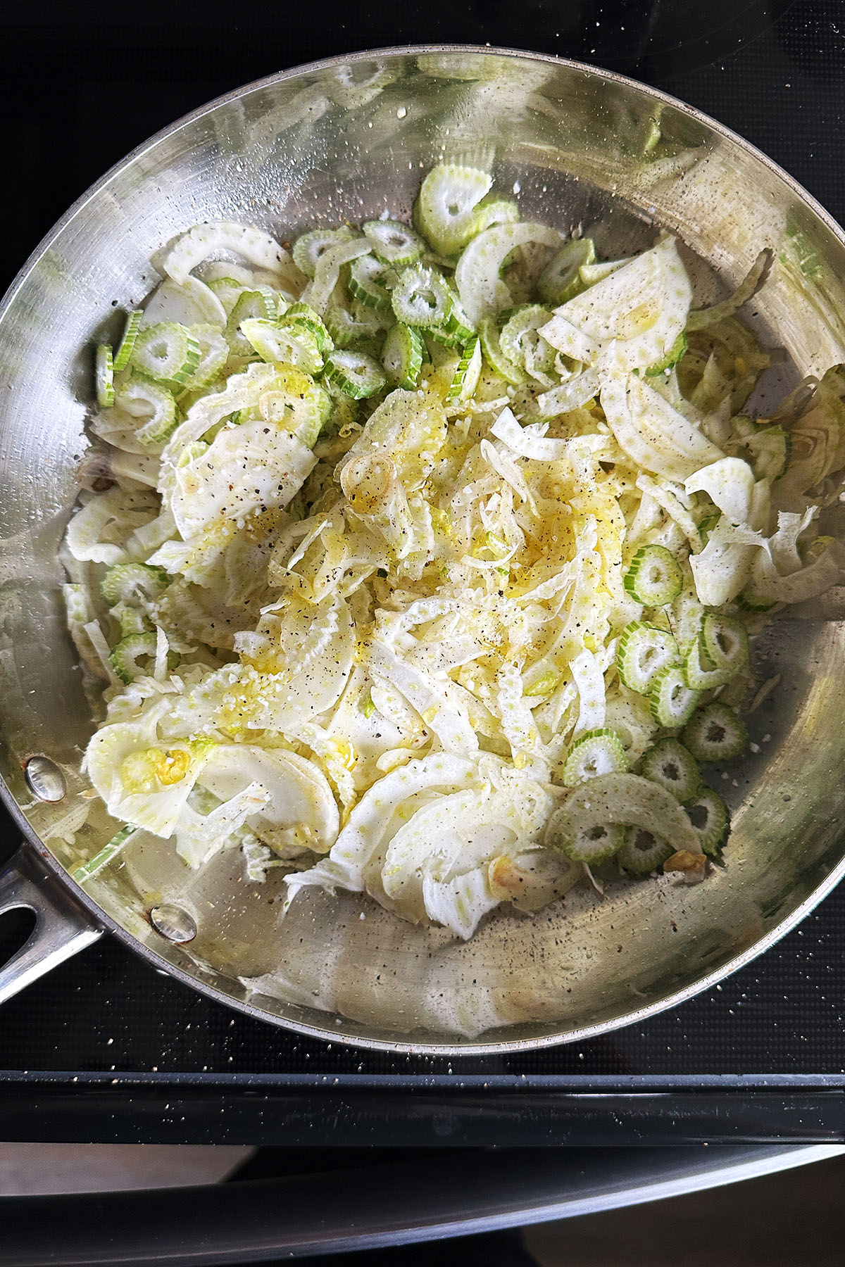 Sliced fennel in a skillet.