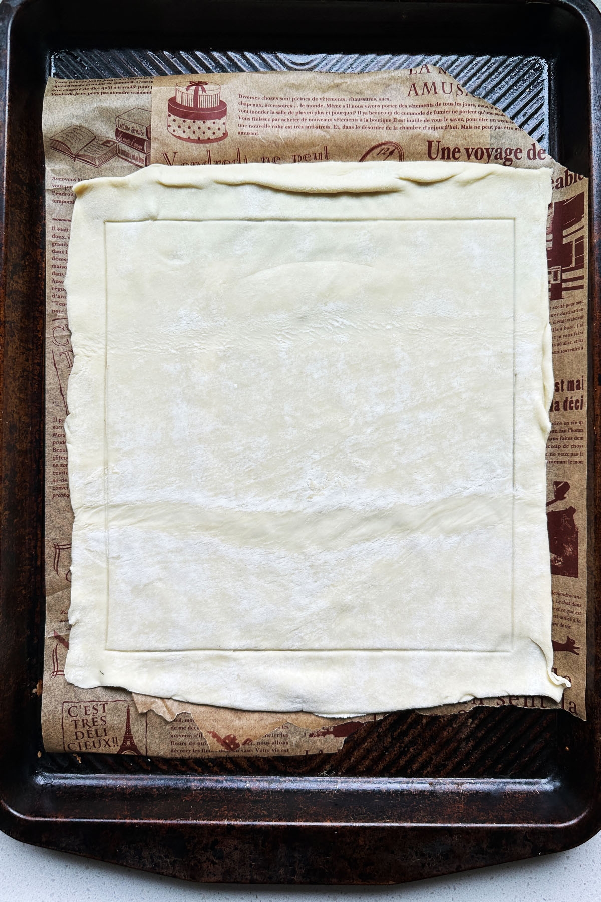 A sheet of puff pastry on a baking sheet.