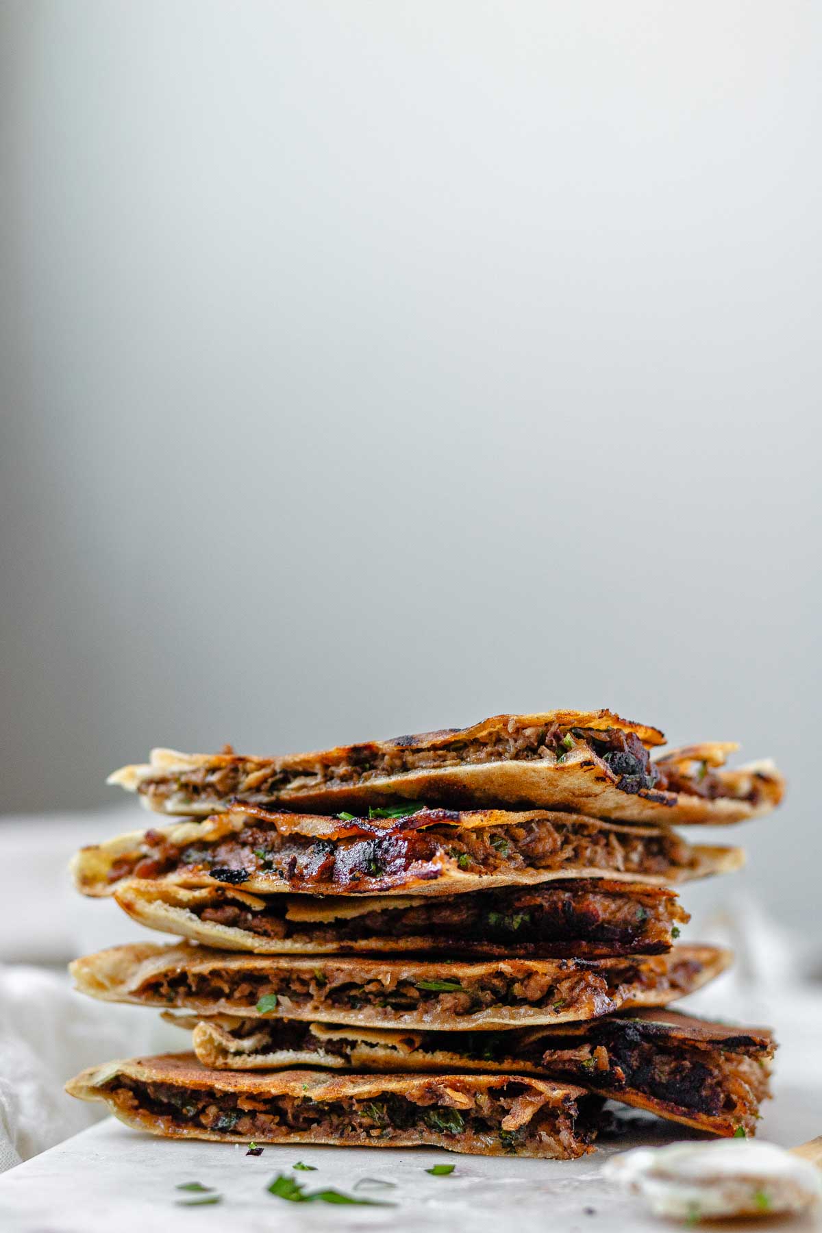 A stack of meat-filled fried pitas.