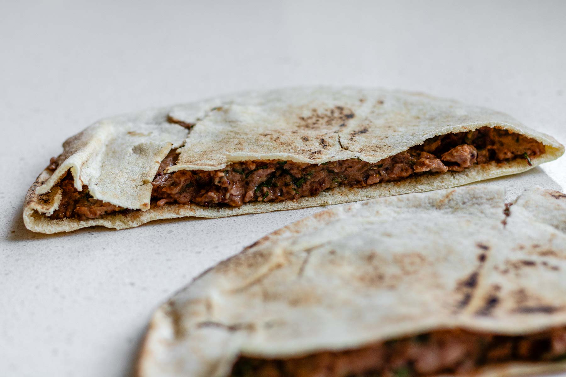Half a pita stuffed with herb-filled meat.