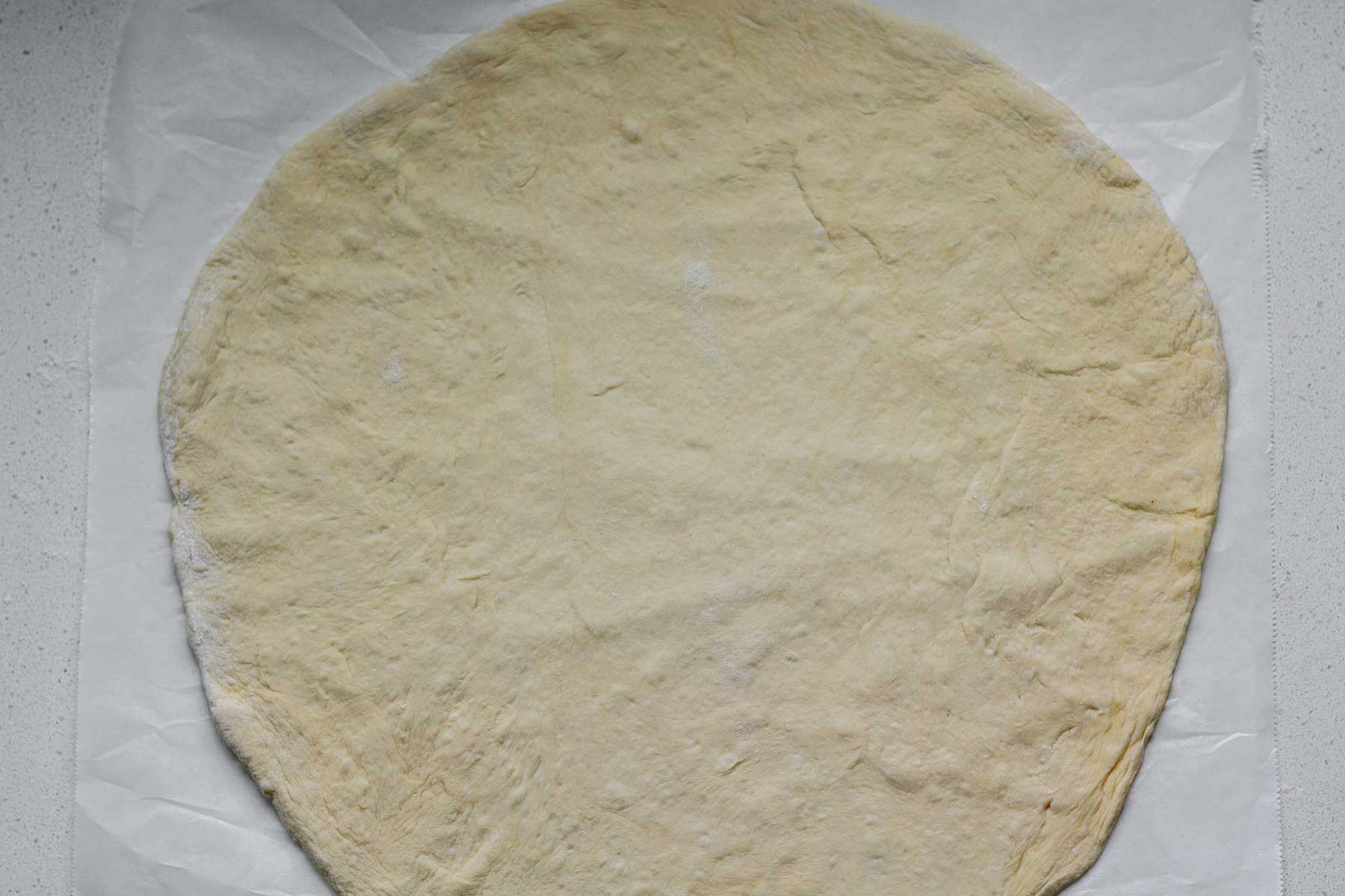 Uncooked flatbread dough.