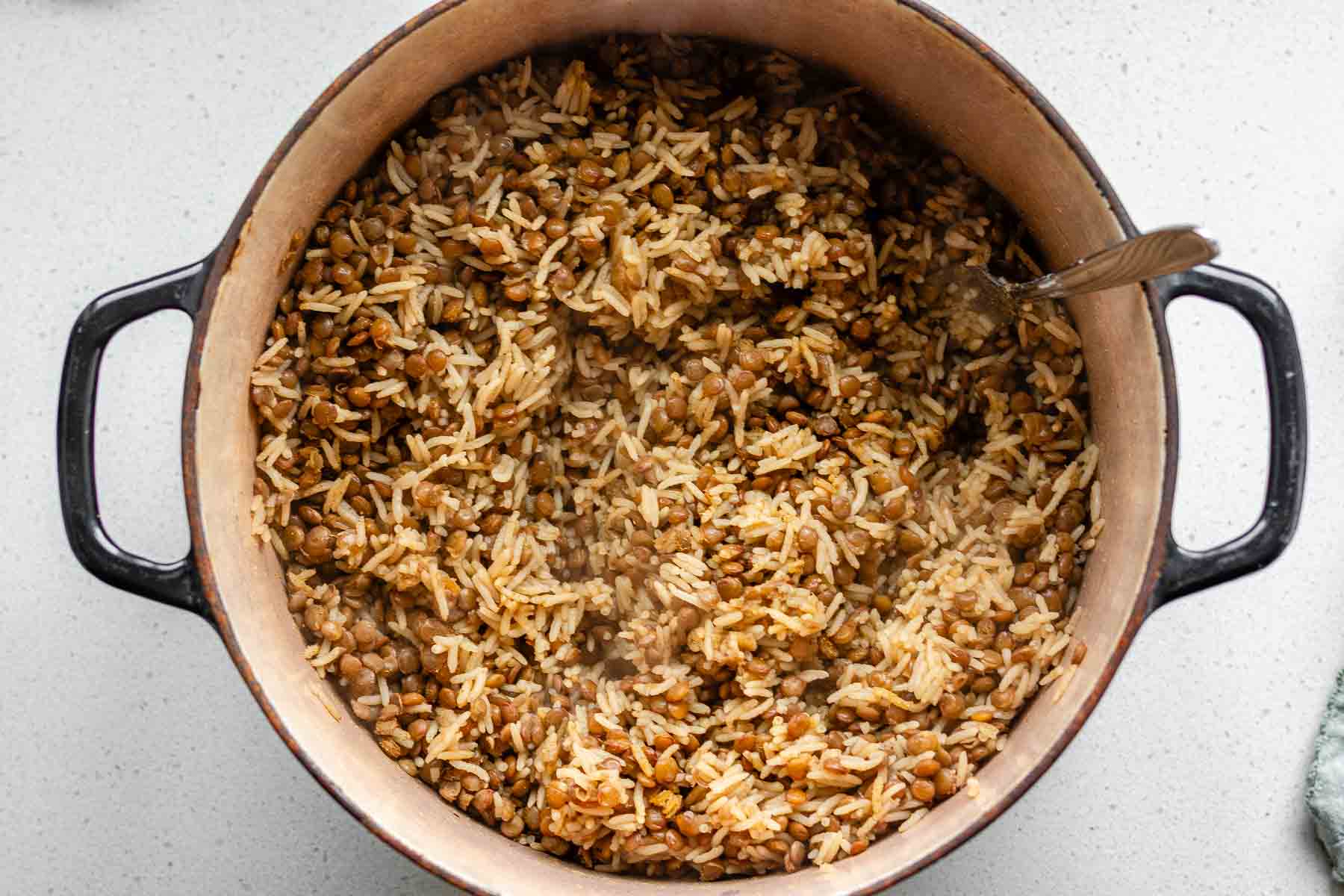 Cooked rice and lentils in a pot.