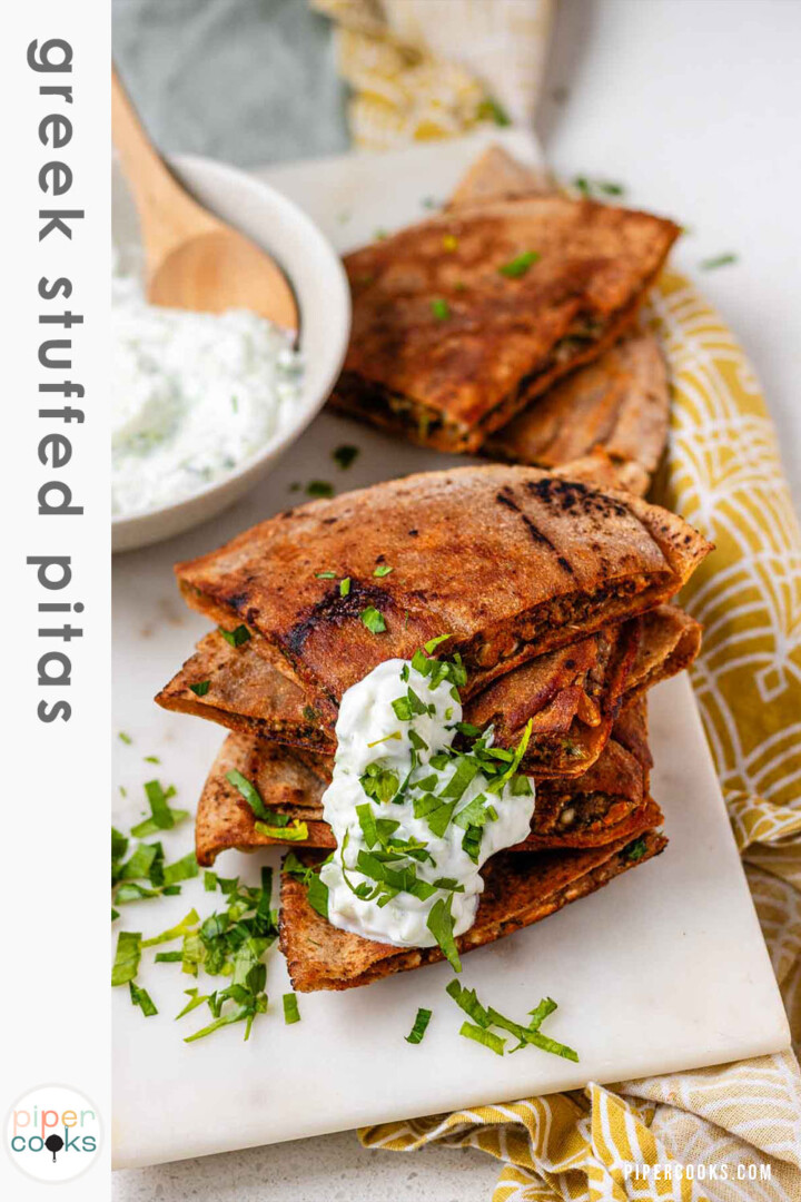 A stack of meat-filled fried pitas with tzatziki sauce and fresh parsley on top, with the text Greek stuffed pitas.