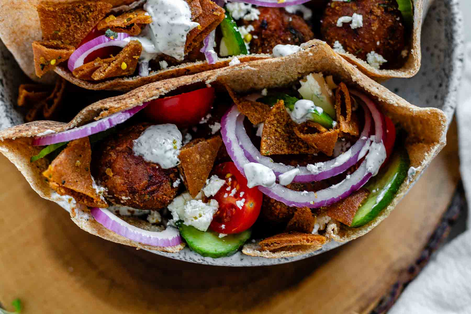 Pita stuffed with meatballs, tomato, cucumber, onion, tzatziki, and crispy pita bits.