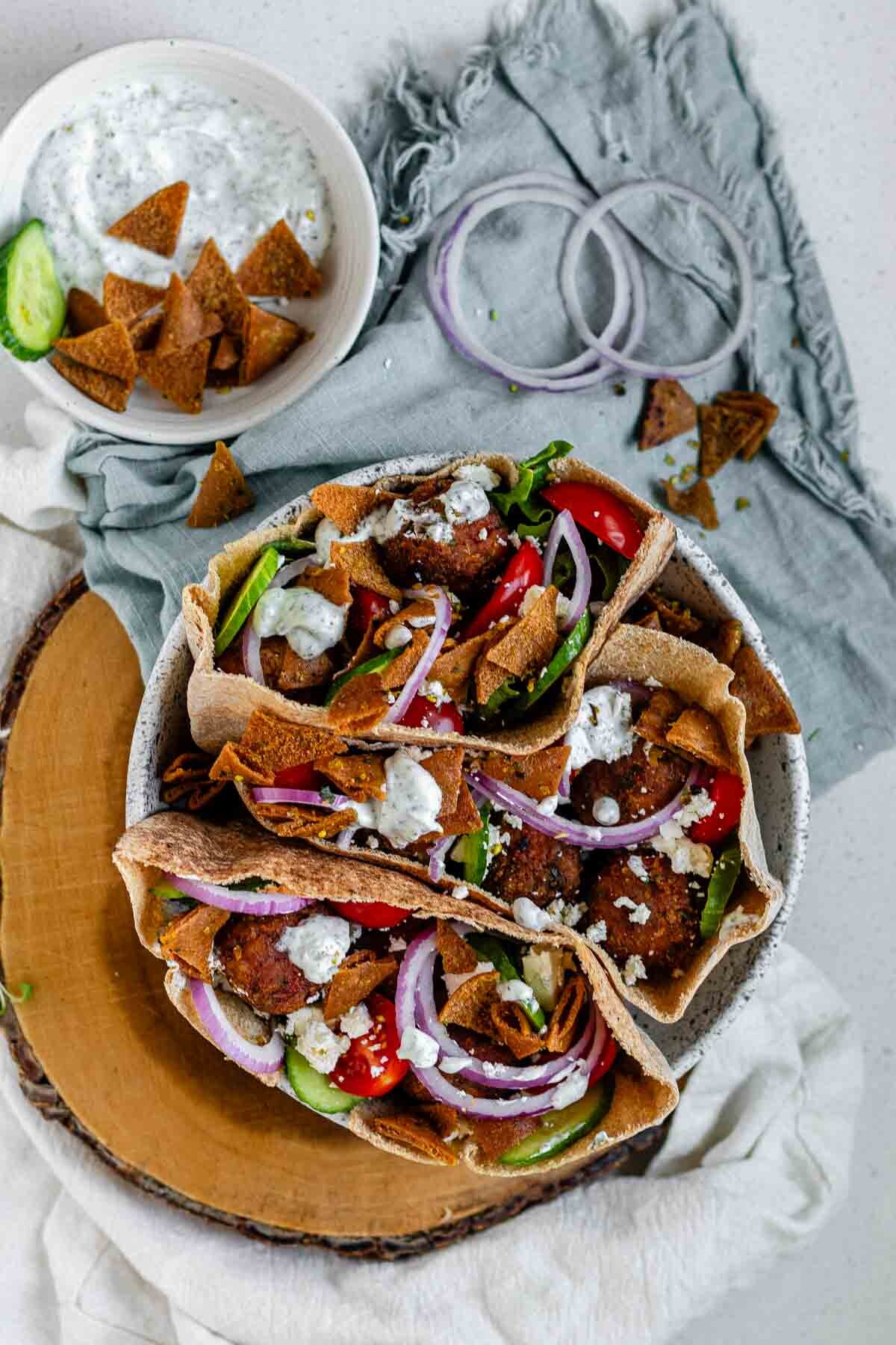 Pita stuffed with meatballs, tomato, cucumber, onion, tzatziki, and crispy pita bits.