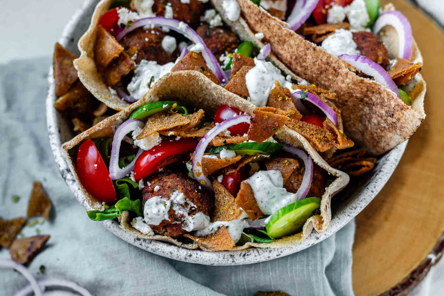 Pita stuffed with meatballs, tomato, cucumber, onion, tzatziki, and crispy pita bits.