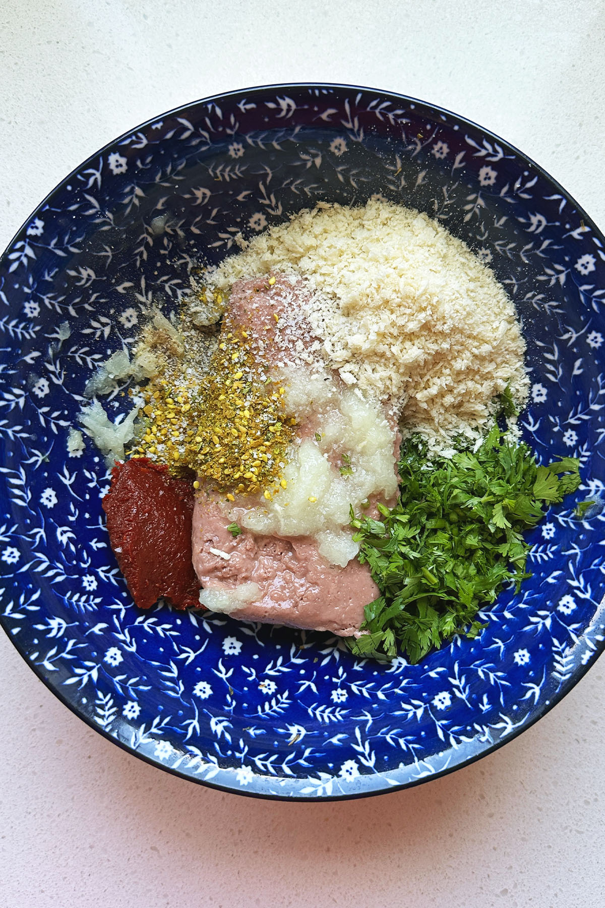 Meatball ingredients in a blue bowl.