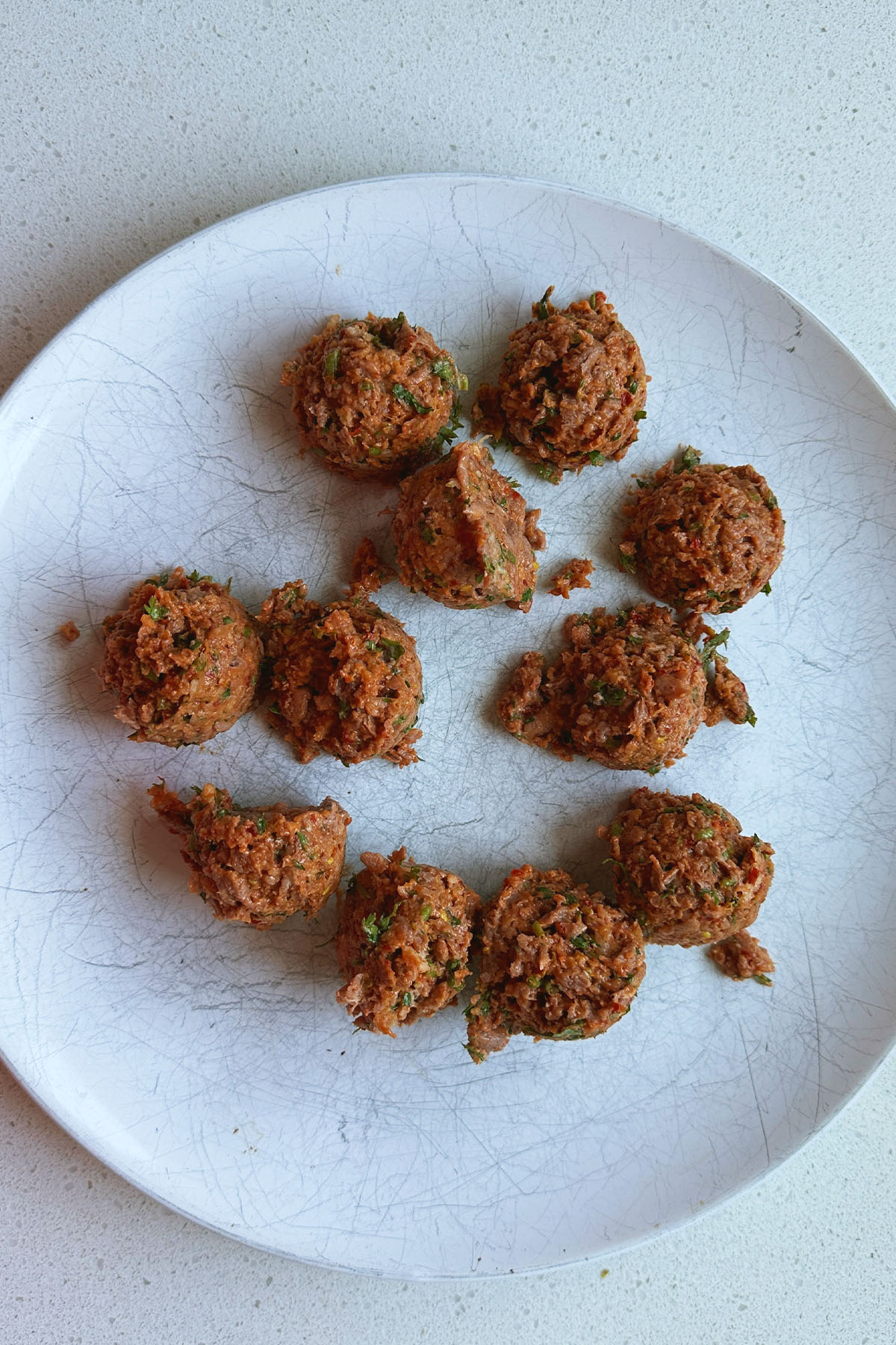 Meatballs scooped onto a plate.