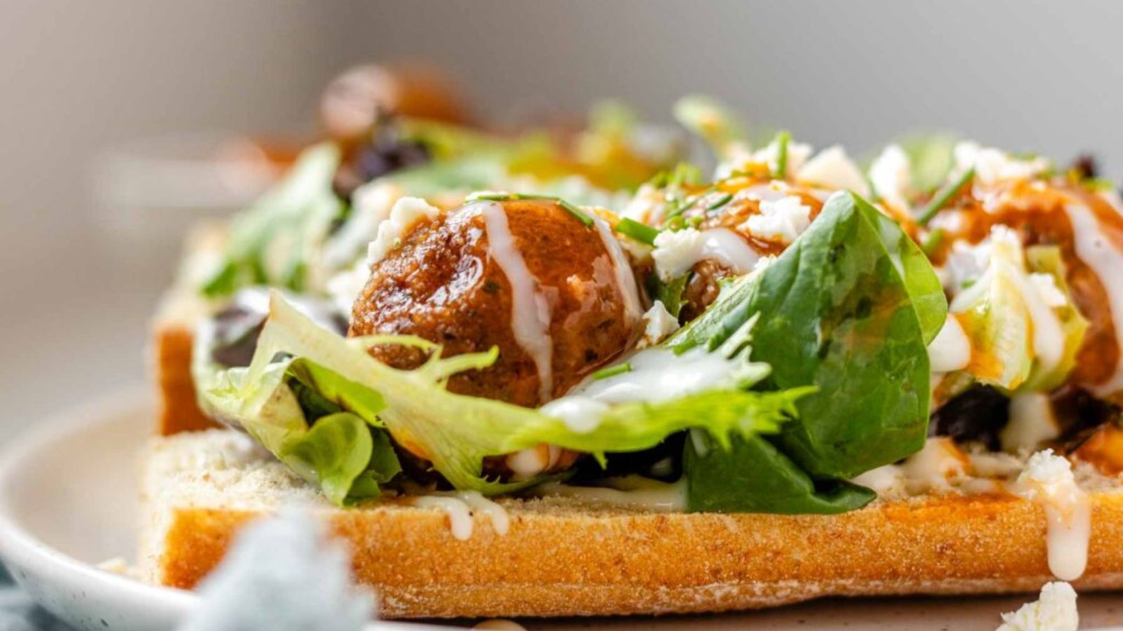 A meatball sandwich on a plate.