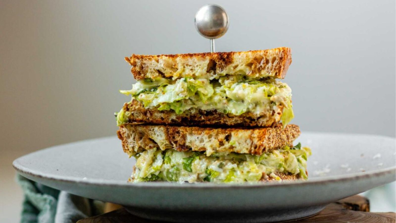 A stacked, halved sandwich on a plate.