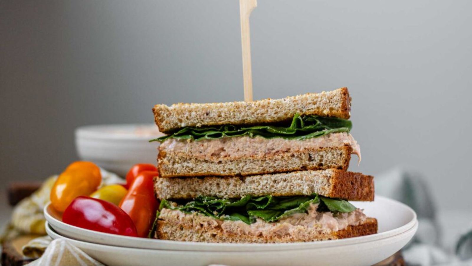 A stacked, halved sandwich on a plate.