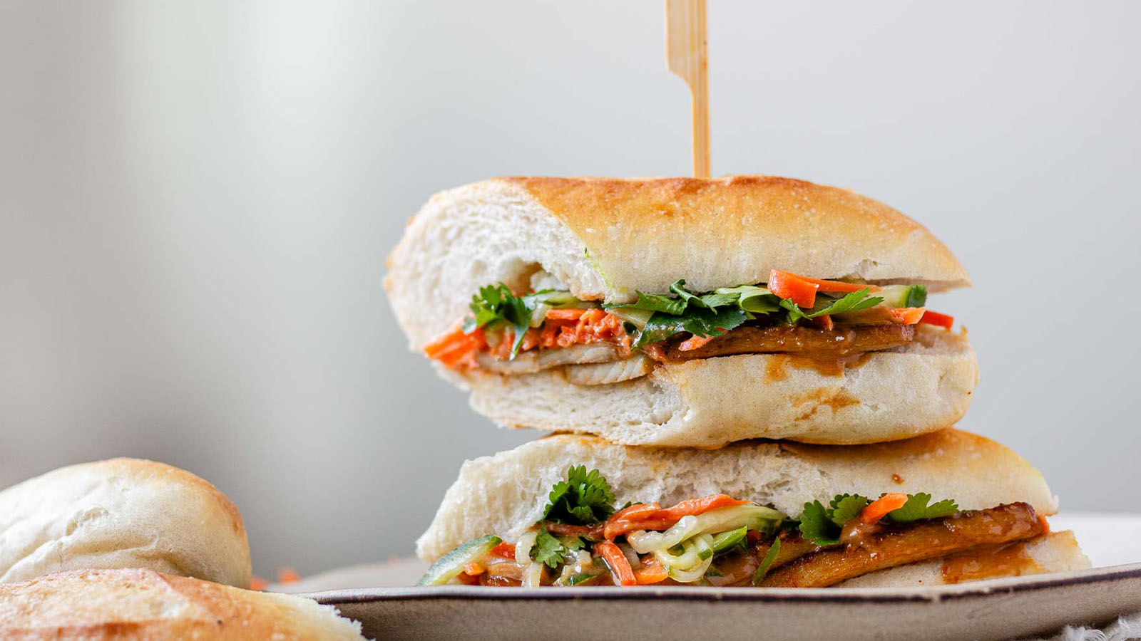 A stacked, halved sandwich on a plate.