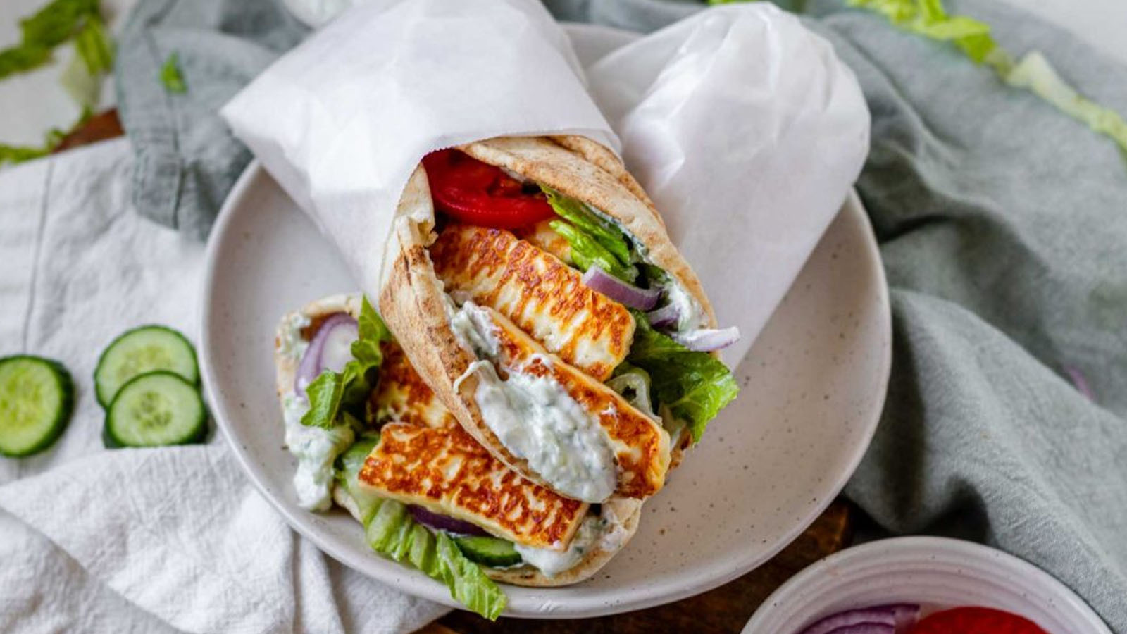 Stacked filled pitas on a plate.