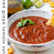 Salsa in a bowl with the text charred grape tomato salsa.