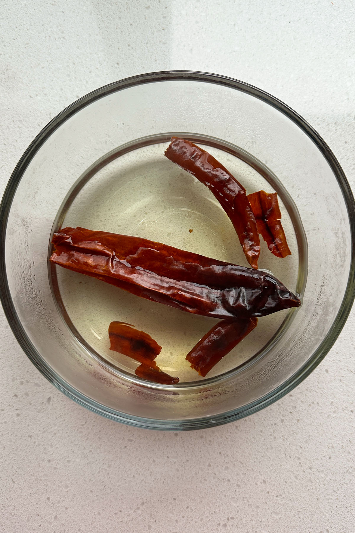 Dried chilies in a bowl of water.