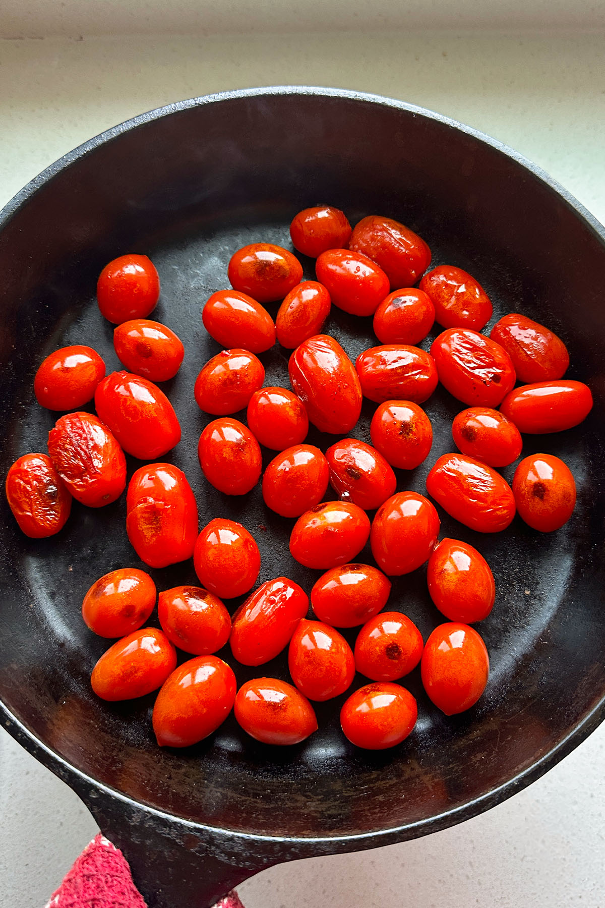 Grape tomatoes in a cast iron skillet.