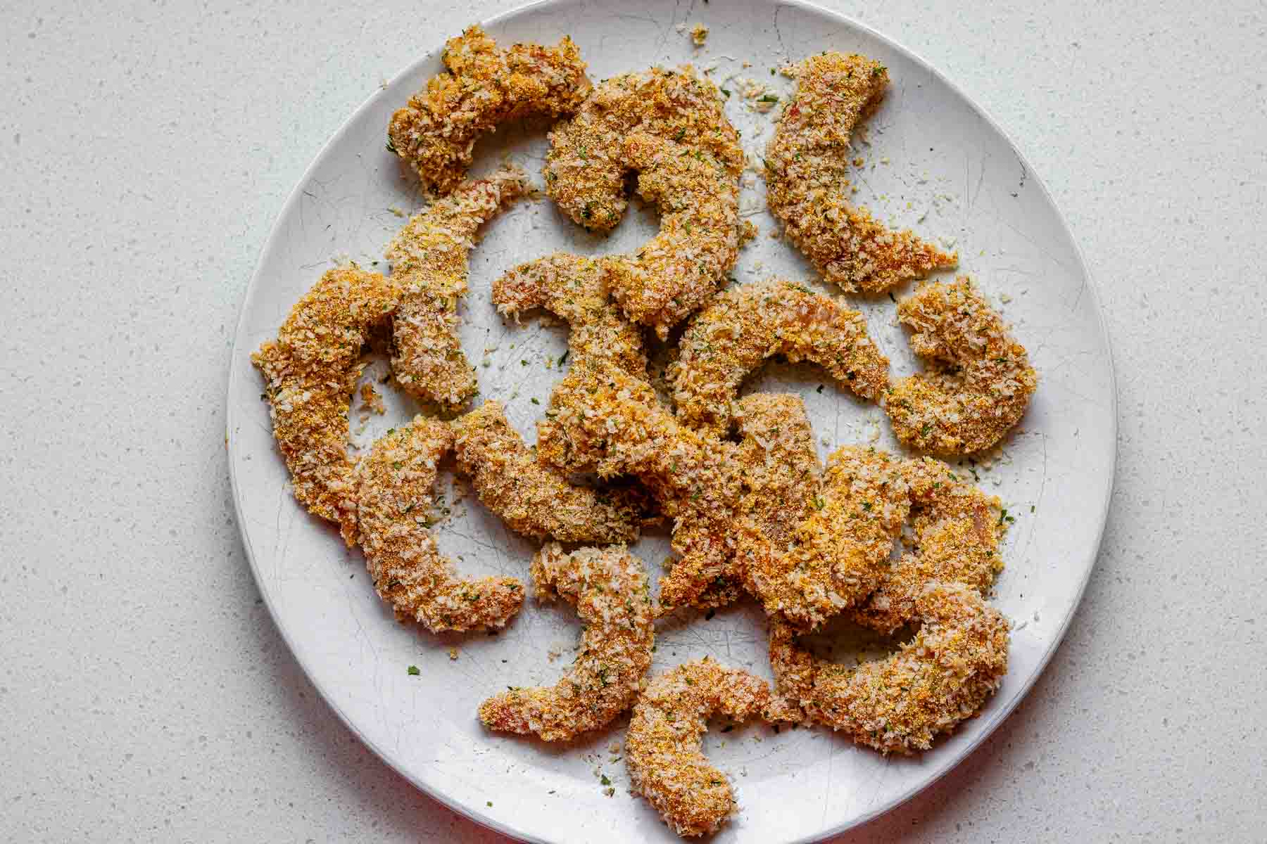 Uncooked breadcrumb coated shrimp.
