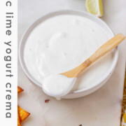 A white sauce in a bowl with the text garlic lime yogurt crema.
