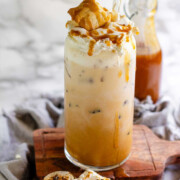 Peanut butter marshmallow iced latte with homemade syrups, topped with toasted marshmallows and peanut butter syrup drizzle with the text fluffernutter iced coffee.