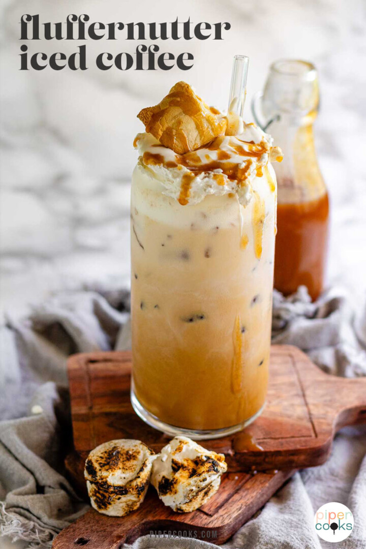 Peanut butter marshmallow iced latte with homemade syrups, topped with toasted marshmallows and peanut butter syrup drizzle with the text fluffernutter iced coffee.