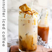 Peanut butter marshmallow iced latte with homemade syrups, topped with toasted marshmallows and peanut butter syrup drizzle with the text fluffernutter iced coffee.
