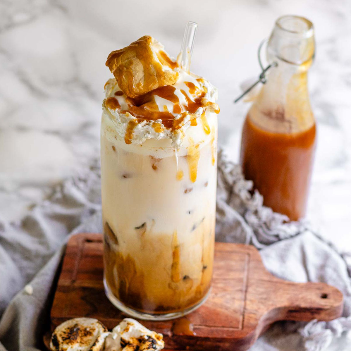 Peanut butter marshmallow iced latte with homemade syrups, topped with toasted marshmallows and peanut butter syrup drizzle.