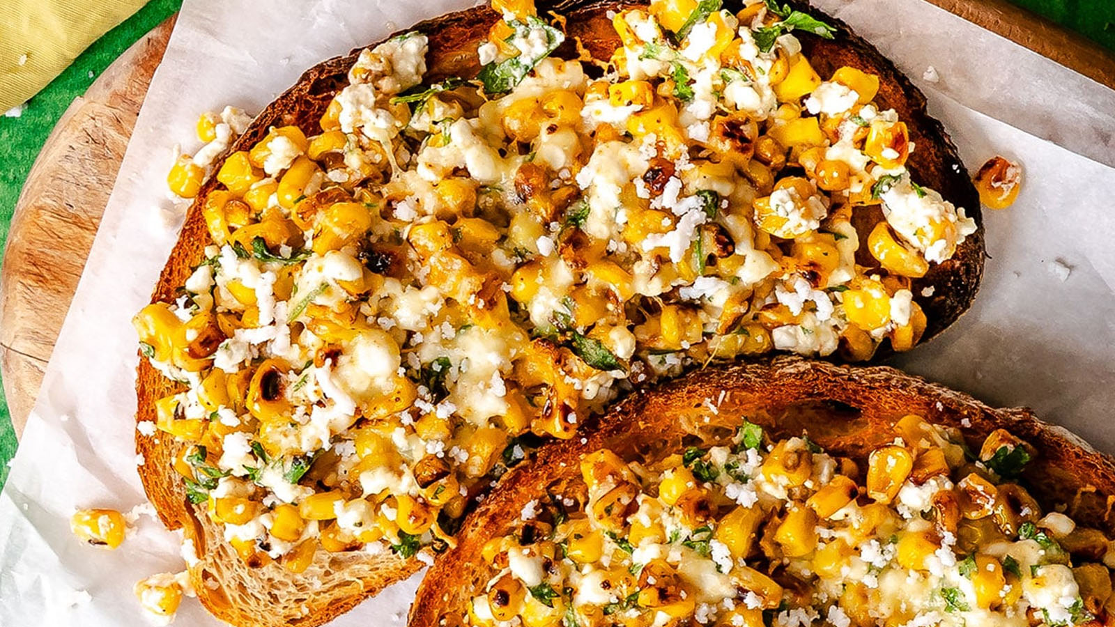 Toast topped with cottage cheese, charred corn, cotija cheese, cilantro, and chili powder