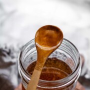 Toasted marshmallow syrup in a glass jar with toasted marshmallows.