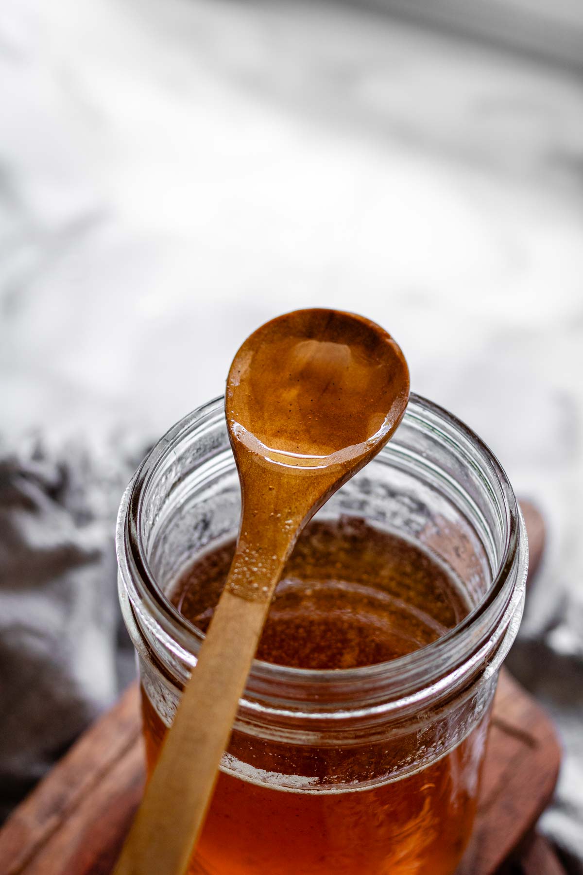 Toasted marshmallow syrup in a glass jar with toasted marshmallows.
