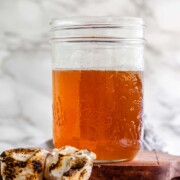 Toasted marshmallow syrup in a glass jar with toasted marshmallows.