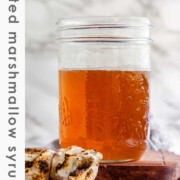 Toasted marshmallow syrup in a glass jar with toasted marshmallows with the text toasted marshmallow syrup.