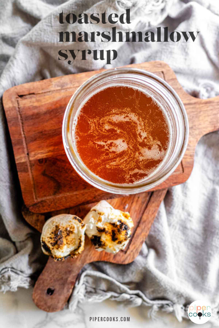 Toasted marshmallow syrup in a glass jar with toasted marshmallows with the text toasted marshmallow syrup.