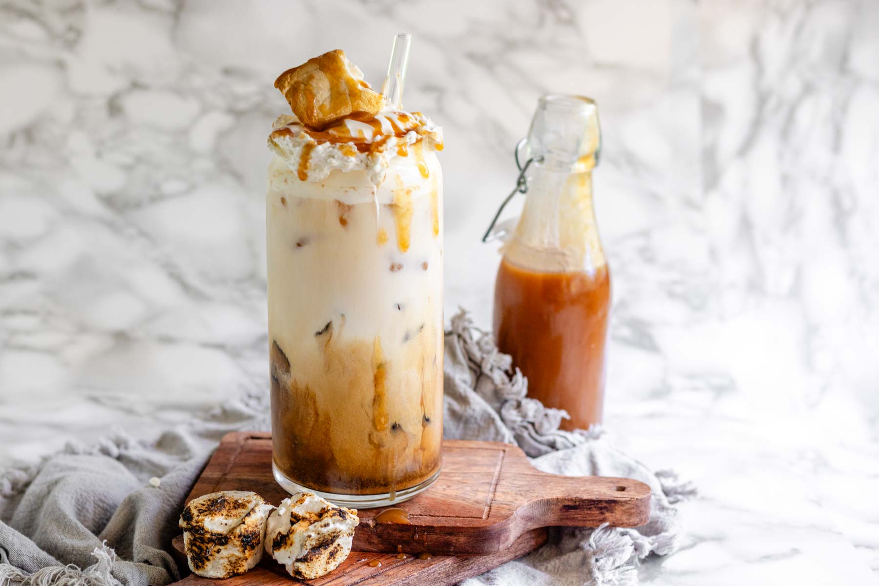 Peanut butter marshmallow iced latte with homemade syrups, topped with toasted marshmallows and peanut butter syrup drizzle.